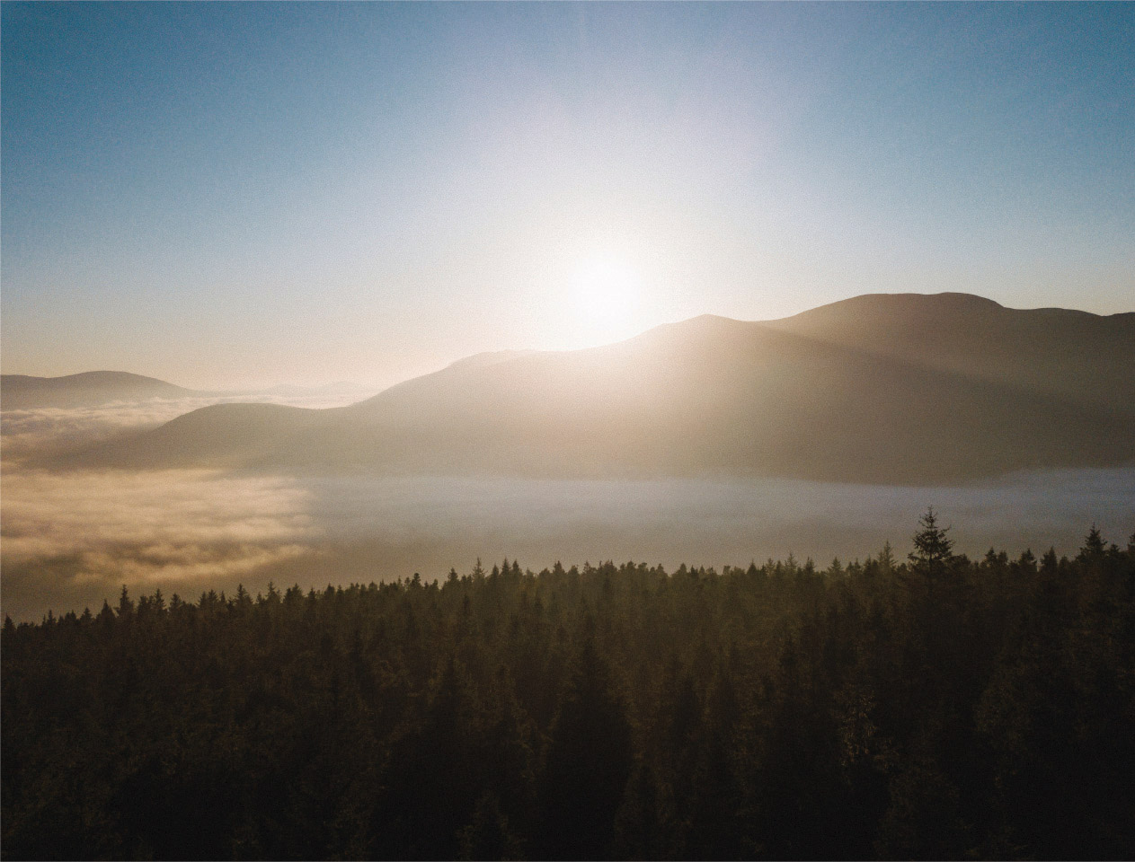 Sunrise over Langford’s forested hills